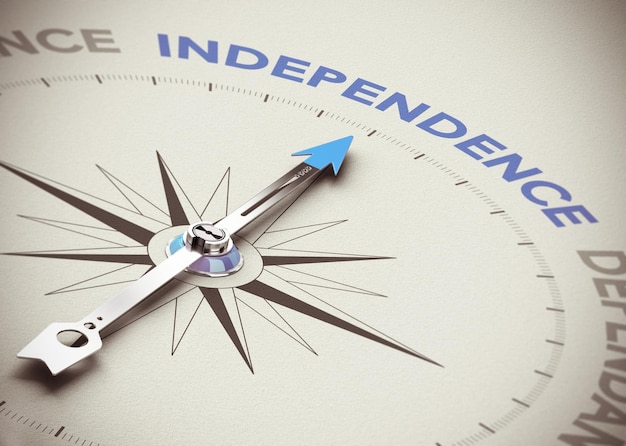 Conceptual 3D render image with depth of field blur effect. Compass needle pointing the blue word independence over natural paper background.