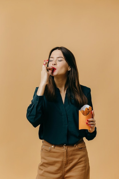 Photo conceptual advertising of fast food a girl with a burger on a colored background contemporary art