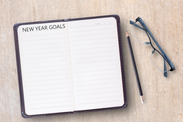 Conceptual business of notebooklaptop computer with new year goals word