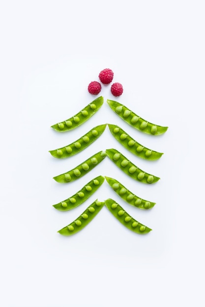 Conceptual christmas tree. Peas and raspberries