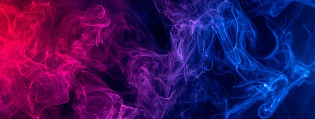 Conceptual image of colorful red and blue color smoke on dark black background