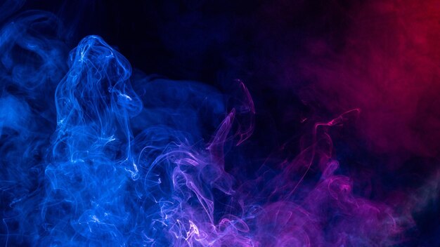 Conceptual image of colorful red and blue color smoke isolated on dark black background halloween concept design element