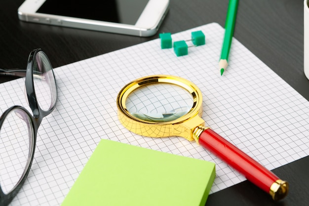 Photo conceptual image depicting conducting an online search for information with a magnifying glass