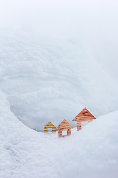 Conceptual paper houses in snow forest