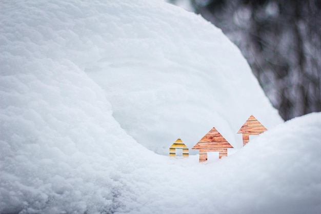 Conceptual paper houses in snow forest