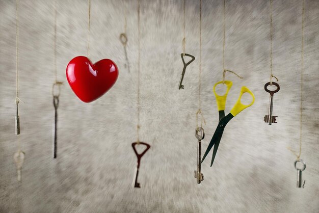 Conceptual photo hand stretching for one of the many old vintage keys hanging on threads