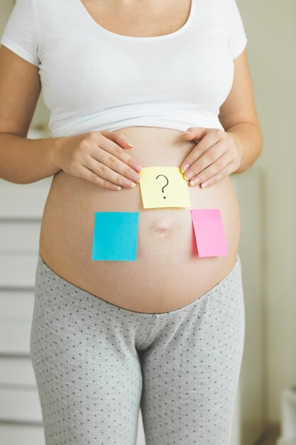 Conceptual photo of pregnant woman thinking of future baby gender