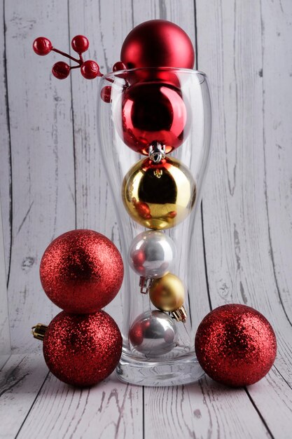 conceptual still life of tall glass with christmas balls