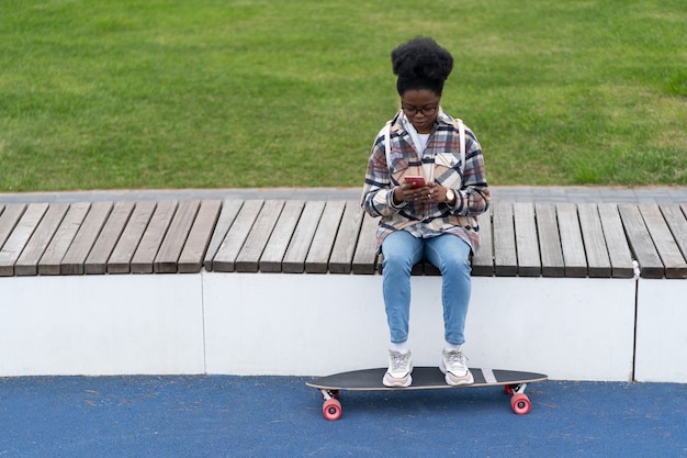 Concerned african woman hold smartphone texting outdoors
serious read email message online in phone