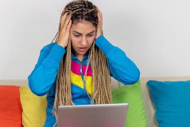 Concerned annoyed teenager girl having problems with software banking service getting bad news