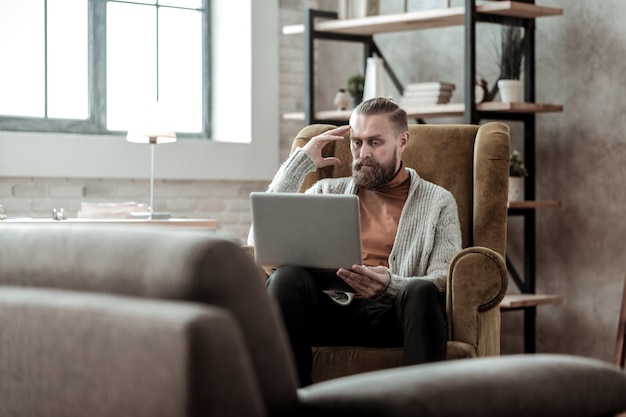 Concerned psychologist. Professional bearded psychologist feeling concerned about his client