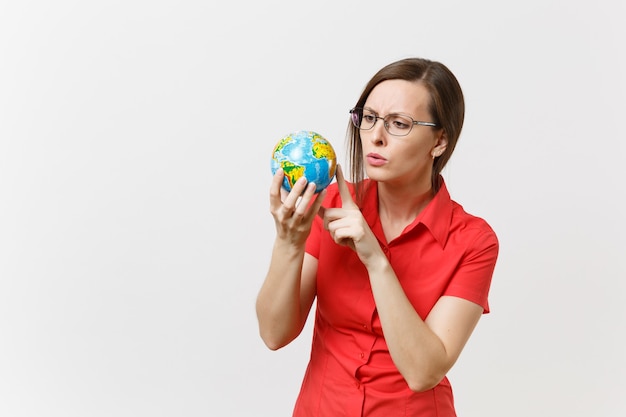 Concerned sad business or teacher woman in red shirt holding in palms Earth globe isolated on white background. Problem of environmental pollution. Stop nature garbage, environment protection concept.