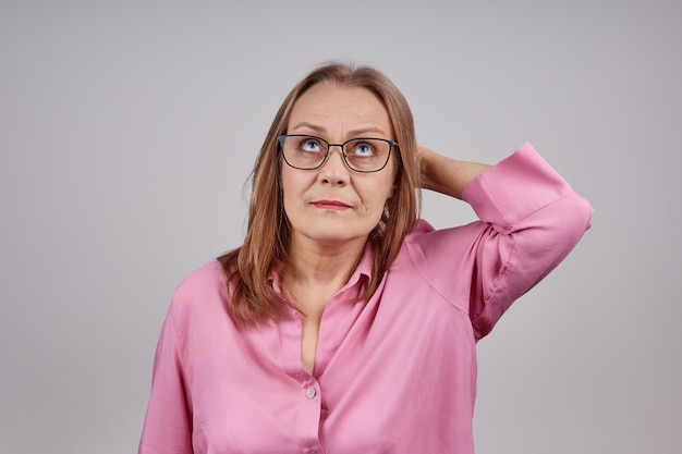 Concerned senior lady with pink blouse