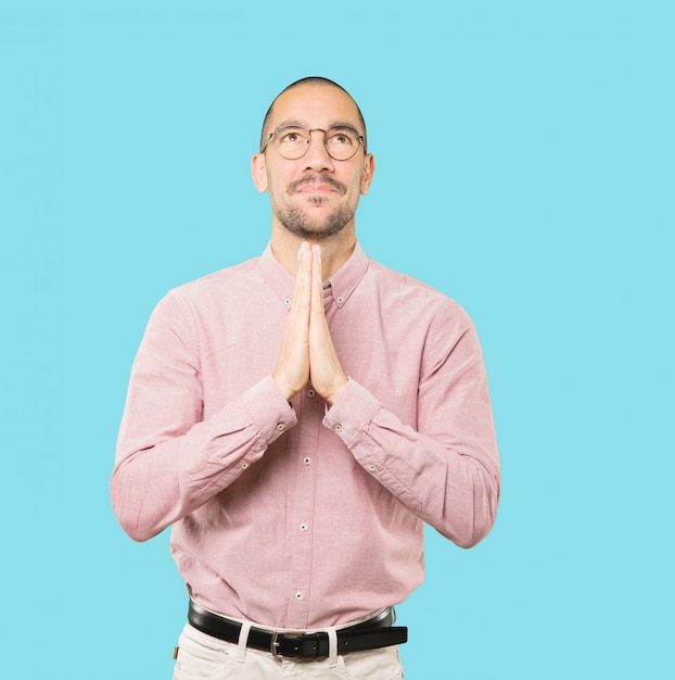 Concerned young man praying gesture