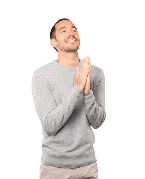 Concerned young man praying gesture