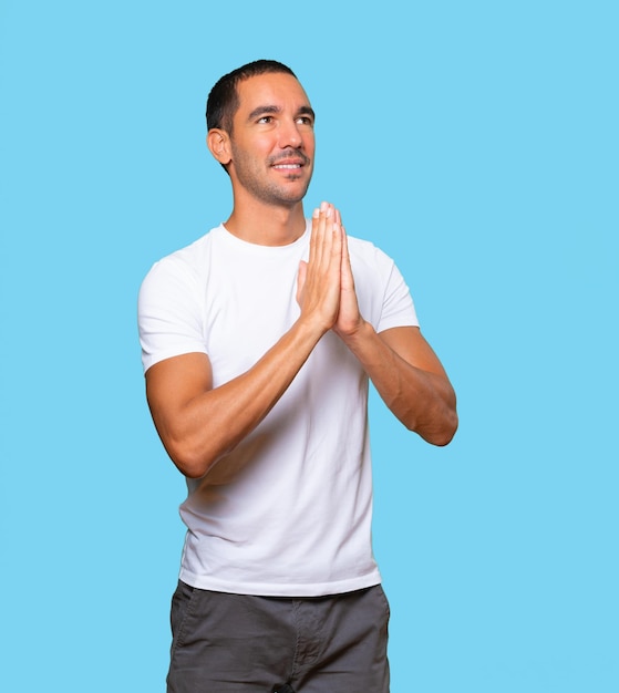 Concerned young man praying gesture