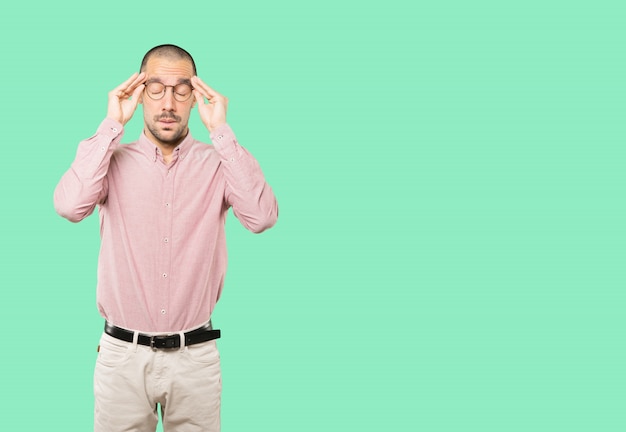 Concerned young man with a stress gesture