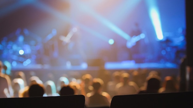 Concert background - silhouette of people dancing at the concert