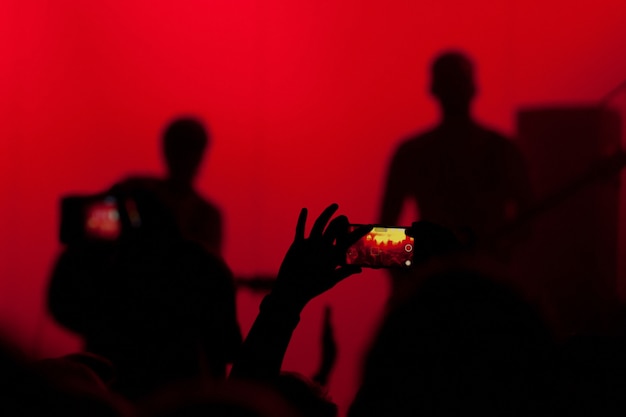 Photo concert crowd takes video and photo of the concert on the phone