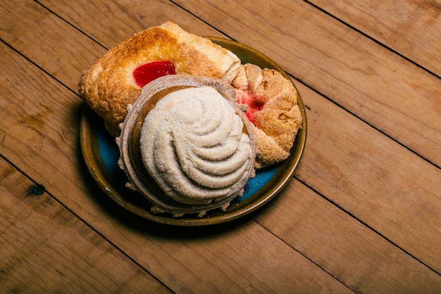 Concha and other sweet breads on wooden table Typical Mexican desserts