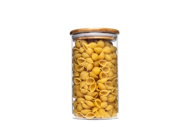 Conchiglie rigate pasta in glass jar isolated