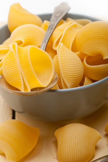 Conchiglies in bowl on table