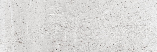 Concrete background texture of old dirty white gray rough\
concrete stone wall as backdrop grunge grey cement surface like\
structure paper material close up banner