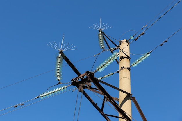 Concrete electricity pylon with glass insulators and bird spikes