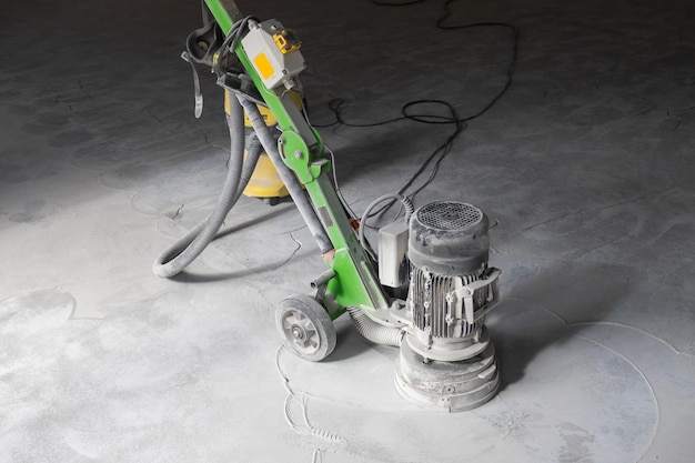 Concrete grinder industrial equipment at work concrete floor
repair in industrial premises