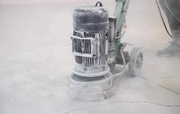 Concrete grinder industrial equipment at work concrete floor\
repair in industrial premises