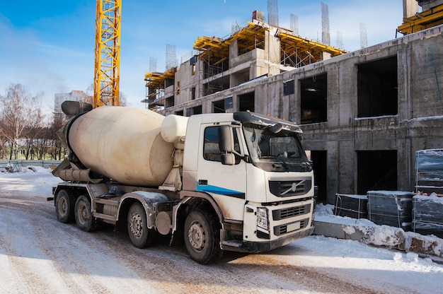 concrete mixer truck stands on construction site in winter