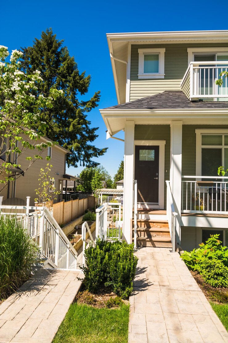 Concrete pathway to the entrance of brand new townhouse on sunny day in canada