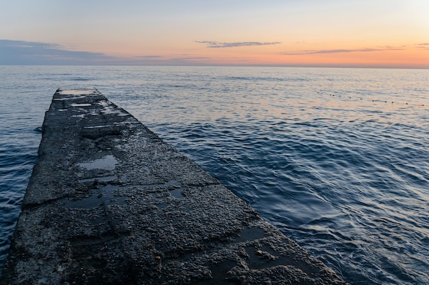 Concrete pier leaving the sea