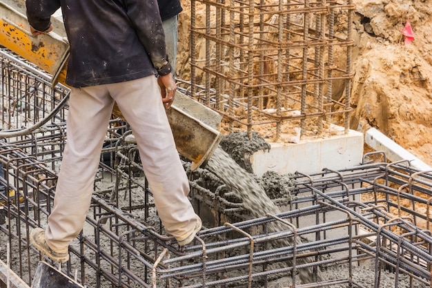 Concrete pouring during commercial concreting floors of buildings in construction site.