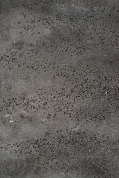Foto fondo concreto di struttura nei colori neri e grigi. piccoli punti di spruzzo.