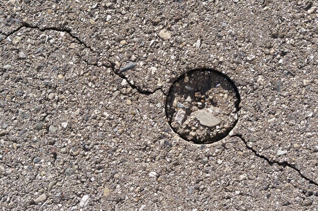 Concrete texture with crack in full screen as background. View from above