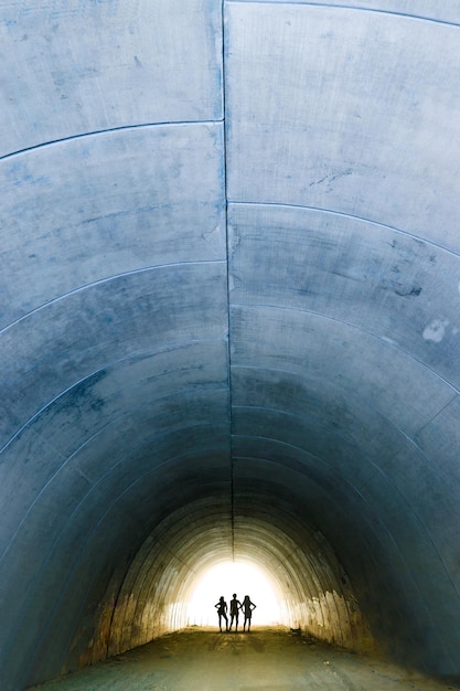 Concrete tunnel and woman silhouettes