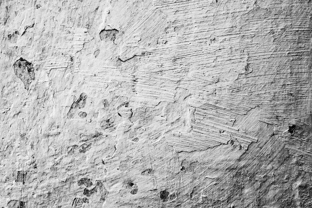 Sfondo texture muro di cemento. frammento di muro con graffi e crepe