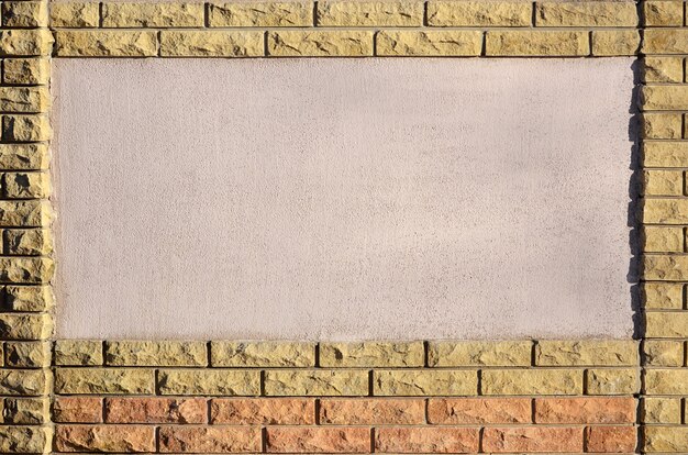 Photo concrete wall with brick frame