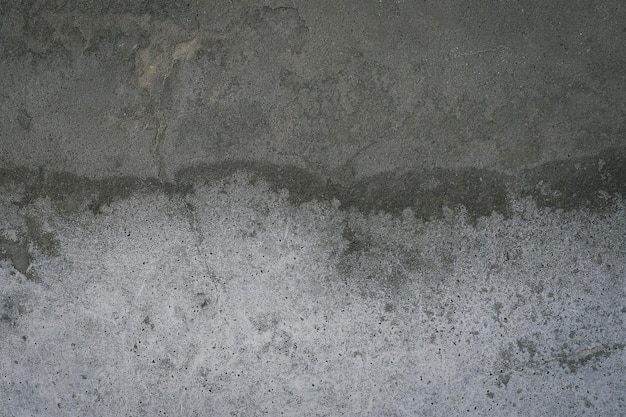 A concrete wall with a rough surface and a white background