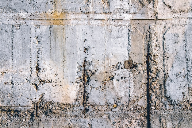 Concrete wall with rusty metal fittings. Can be used as a texture background