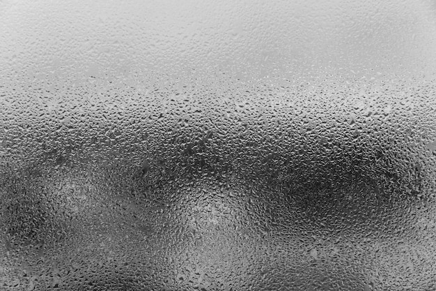 Photo condensation on the glass with smudges of drops. space for text. background: black and white photo.