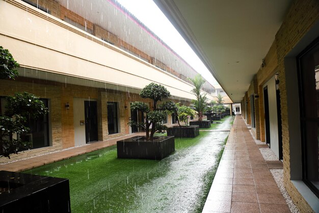 the condition of a green open corridor in a building during heavy rain