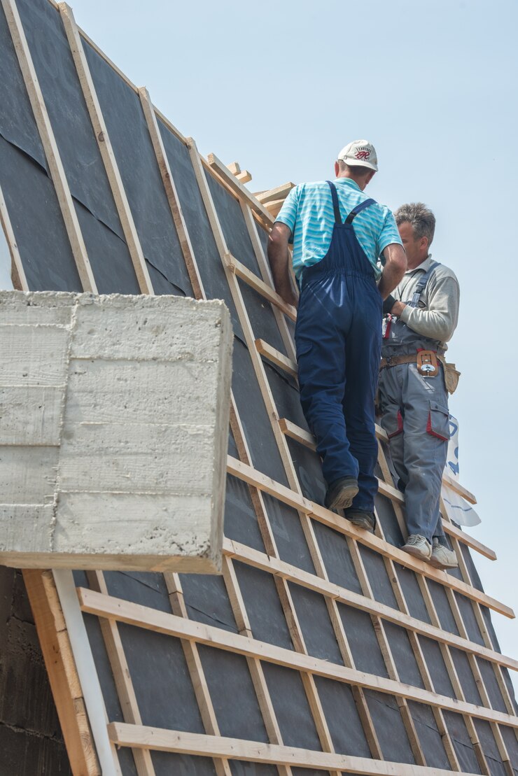 Condo construction with workers on the roof frame