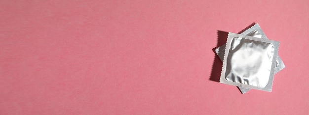 condom on the pink background space for your text