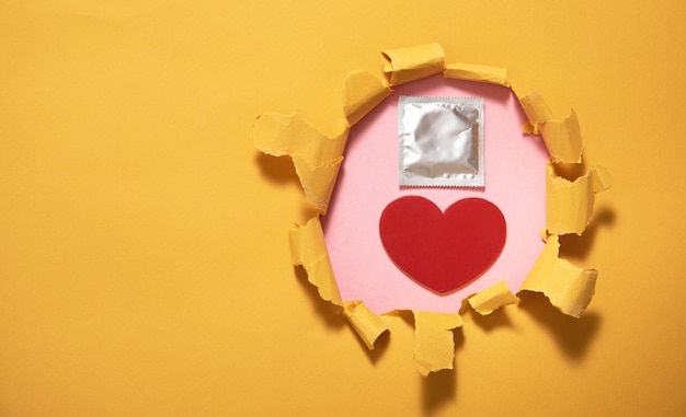 Condom and red heart Safe sex