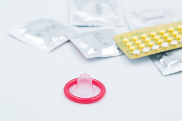 Photo condom with contraceptive birth control pill safe sex