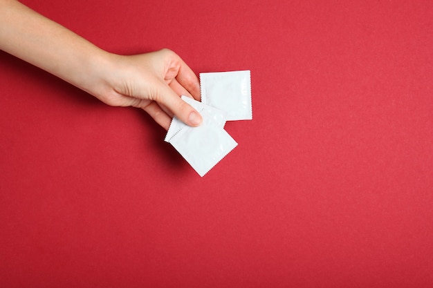 Condoms and other contraceptives on a colored background