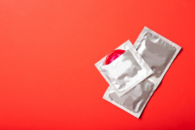 Photo condoms in packages on red background