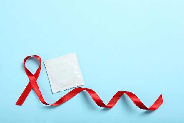 Condoms and red ribbon symbolizing aids world aids day